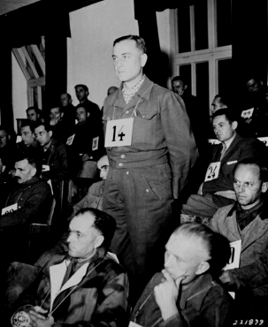 Dr. Hans Eisele stands in the courtroom at Dachau.  