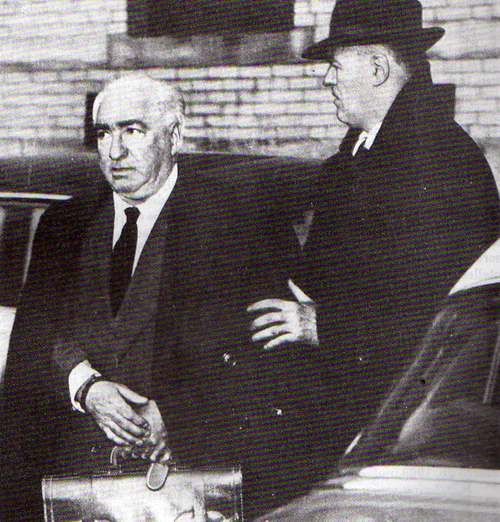 Reich being escorted to prison, March 1957